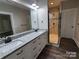 Modern bathroom featuring double vanity with granite countertops and stylish, tiled glass shower with dual showerheads at 404 Imperial Way, Albemarle, NC 28001