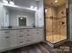 Well-lit bathroom offers a spacious walk-in shower with glass enclosure, and double sink vanity at 404 Imperial Way, Albemarle, NC 28001
