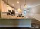 Kitchen island with pendant lighting and modern stainless appliances at 404 Imperial Way, Albemarle, NC 28001