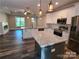 Open concept with kitchen island, stainless steel appliances, and electric fireplace at 404 Imperial Way, Albemarle, NC 28001