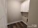 Bright laundry room with a set of white cabinets and washer/dryer hookups at 404 Imperial Way, Albemarle, NC 28001