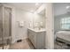 Bathroom featuring a double sink vanity, large mirror, and a glass-enclosed shower at 4548 Millennium Ave, Charlotte, NC 28217