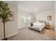 Serene bedroom featuring neutral walls, plush carpet, and a cozy bed with stylish decor at 4548 Millennium Ave, Charlotte, NC 28217