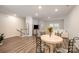 Open-concept dining room with hardwood floors, stylish furniture, and plenty of space for entertaining at 4548 Millennium Ave, Charlotte, NC 28217