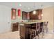 Kitchen featuring dark wood cabinets, stainless steel appliances, and bar stool seating at 4750 Kay Bird Ln, Concord, NC 28027