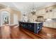 Spacious kitchen with granite countertops, dark island, wood floors and stainless steel appliances at 4750 Kay Bird Ln, Concord, NC 28027