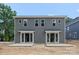 Back exterior of home with sliding glass doors and concrete patios at 507 Bowman Rd, Charlotte, NC 28217