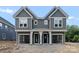 New construction two-story home with gray siding, white trim, covered porch, and garage at 507 Bowman Rd, Charlotte, NC 28217