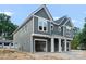 Gray home with white trim, covered porch, and garage at 507 Bowman Rd, Charlotte, NC 28217
