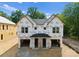 New construction home featuring a modern design with an unfinished garage and covered entryways at 507 Bowman Rd, Charlotte, NC 28217