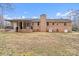 Exterior view of the brick home with an outdoor patio area, showing the spacious backyard at 512 Rhodes Ave, Kings Mountain, NC 28086