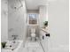 Updated bathroom featuring marble tile shower, a large tub, granite counters, and modern hardware at 512 Rhodes Ave, Kings Mountain, NC 28086