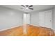 Bright bedroom featuring hardwood floors, a ceiling fan, and a double door closet at 512 Rhodes Ave, Kings Mountain, NC 28086