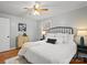Bright bedroom featuring hardwood floors, a ceiling fan, and a decorative headboard at 512 Rhodes Ave, Kings Mountain, NC 28086