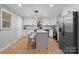 Beautiful updated kitchen with island, stainless appliances, white cabinetry and pendant lighting at 512 Rhodes Ave, Kings Mountain, NC 28086