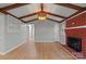 Large living room featuring vaulted ceilings, hardwood floors, and a brick fireplace at 512 Rhodes Ave, Kings Mountain, NC 28086