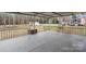 Covered patio with metal railing overlooks the spacious backyard at 512 Rhodes Ave, Kings Mountain, NC 28086