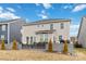 View of the back exterior showing large windows, multiple levels, and an outdoor seating area for relaxing or entertaining at 531 Red Wolf Ln, Clover, SC 29710