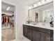 Bathroom with double sinks, vanity, decorative mirror and view to walk-in closet at 531 Red Wolf Ln, Clover, SC 29710
