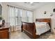 Comfortable bedroom with three bright windows, neutral paint, carpet, and a spacious wood bed at 531 Red Wolf Ln, Clover, SC 29710