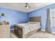 Cozy bedroom with neutral paint, carpet, a spacious wood bed, and bright natural light at 531 Red Wolf Ln, Clover, SC 29710