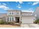 Two story home featuring a two car garage, covered entrance and neutral toned siding at 531 Red Wolf Ln, Clover, SC 29710