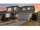 Two story home featuring a two car garage and neutral toned siding and brick accents at 531 Red Wolf Ln, Clover, SC 29710