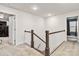 Upstairs hallway with wood-and-white banister and doors to rooms at 531 Red Wolf Ln, Clover, SC 29710