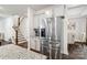Kitchen with stainless steel refrigerator, granite countertops, white cabinets, and a view of the staircase at 531 Red Wolf Ln, Clover, SC 29710