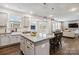 Open concept kitchen featuring a granite island with breakfast bar that connects to the living room area at 531 Red Wolf Ln, Clover, SC 29710