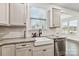 Close up of a kitchen sink featuring granite counter tops, white subway tile back splash and white cabinets at 531 Red Wolf Ln, Clover, SC 29710