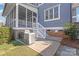 Well-equipped backyard featuring a built-in grill, cozy screened porch, and outdoor stairs at 5717 Closeburn Rd, Charlotte, NC 28210