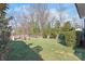 Expansive backyard features lush lawn, mature trees, privacy fence, and dedicated firepit area at 5717 Closeburn Rd, Charlotte, NC 28210