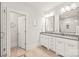 Bright bathroom featuring double vanities, modern fixtures, and a separate water closet with herringbone tile at 5717 Closeburn Rd, Charlotte, NC 28210