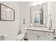 Elegant bathroom with a modern vanity, stylish mirror, and neutral color palette at 5717 Closeburn Rd, Charlotte, NC 28210