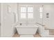 Relaxing bathroom with a soaking tub, walk-in shower with glass door and bright natural light at 5717 Closeburn Rd, Charlotte, NC 28210