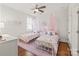 Charming bedroom with two twin beds, whimsical decor, and plenty of natural light at 5717 Closeburn Rd, Charlotte, NC 28210
