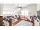 A fun bonus room or playroom with hardwood floors, a ceiling fan, lots of windows, and comfortable seating at 5717 Closeburn Rd, Charlotte, NC 28210