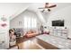 Playful bonus room boasts hardwood floors, a ceiling fan, TV, and organized storage solutions at 5717 Closeburn Rd, Charlotte, NC 28210
