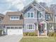 Charming two-story home featuring a two-car garage, manicured lawn, and inviting front porch at 5717 Closeburn Rd, Charlotte, NC 28210