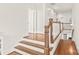 Bright hallway featuring hardwood floors, white trim, and access to multiple rooms at 5717 Closeburn Rd, Charlotte, NC 28210