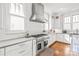 Gourmet kitchen with stainless steel range, white cabinets, and subway tile backsplash at 5717 Closeburn Rd, Charlotte, NC 28210