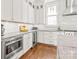 Modern kitchen with white cabinets, stainless steel appliances, and hardwood floors at 5717 Closeburn Rd, Charlotte, NC 28210