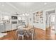 Open-concept living room with built-in bookshelves, a fireplace, and hardwood floors at 5717 Closeburn Rd, Charlotte, NC 28210