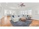 Comfortable living room with a sectional sofa, large windows, and hardwood floors at 5717 Closeburn Rd, Charlotte, NC 28210