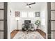 Bright home office with modern decor, wood floors, a ceiling fan, and plenty of natural light from two windows at 5717 Closeburn Rd, Charlotte, NC 28210