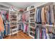 Custom walk-in closet with organized shelving, hanging space, and hardwood floors to maximize storage and convenience at 5717 Closeburn Rd, Charlotte, NC 28210