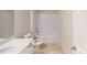 Well-lit bathroom featuring a white vanity, toilet, and a shower-tub combo with tile flooring at 602 Banter Ln # 28, Cramerton, NC 28032