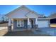 Charming new construction home featuring a welcoming front porch and attached two car garage at 602 Banter Ln # 28, Cramerton, NC 28032