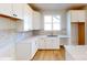 Bright kitchen featuring white cabinets, light countertops, a modern sink, and wooden floors at 602 Banter Ln # 28, Cramerton, NC 28032